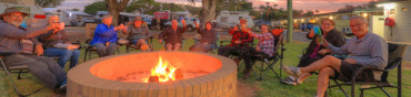 Emerald tourist park happy caravaners around the camp fire image